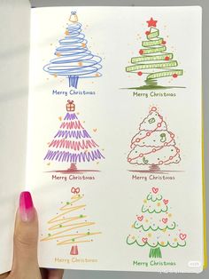 someone is holding up a book with christmas tree designs on it and the words merry christmas written in different languages