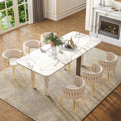 a marble dining table surrounded by chairs and a rug in front of a fire place