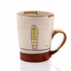 a coffee cup with an image of a banana on the bottom and brown trim around it