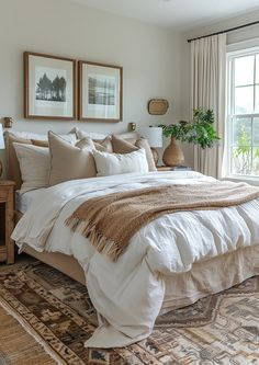 a large bed sitting in a bedroom next to a window