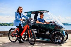 two people riding an electric vehicle on a pier