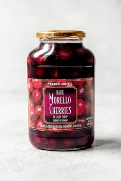 a jar of marzillo cherries sitting on top of a white countertop