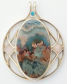 One of a kind, designer pendent with selected gemstones for their uniqueness, color, and metaphysical traits emphasizing health and well being in non-tarnishing Continuum Silver, Prudent Maw Plume Agate, Peach Moonstone cabs, 3mm. Blue Zircon faceted accent. Plume Agate, Peach Moonstone, Blue Zircon, Well Being, Pendant Necklaces, Moonstone, Jewelry Necklace Pendant, Springs, Agate