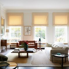 a living room filled with furniture and windows