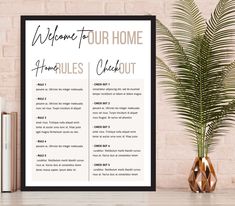 a welcome sign is displayed next to a potted plant and books on a table