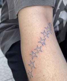 a man's arm with stars on it