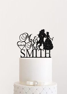 a wedding cake topper that says mr and mrs with the silhouettes of two people