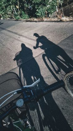 the shadow of two people on a bike