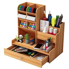 a wooden desk organizer with drawers and pens, pencils, markers and other office supplies