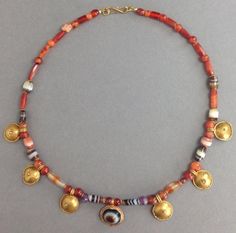 An ancient Roman necklace comprised of gold shields, banded sardonyx, carnelian, and amethyst beads with modern gold clasp Ca. 1st -4th century AD. Overall length: 17 in. (43 cm). Intact and wearable. Roman Necklace, Ancient Necklace, Ancient Roman Jewelry, Art Presents, Gold Shield, Roman Jewelry, Rare Jewelry