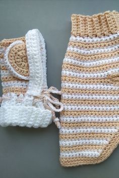 a crocheted baby bootie and diaper cover are laying next to each other