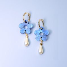 The Daisy Pearl Drops are elegant floral earrings that add a touch of class and polish to any outfit. Perfect for a fancy affair (wedding! date night!) or any occasion when you want to impress and glimmer! Hand-made in studio using beautiful marbled acrylic and glass pearls.  The drops hang from 18mm, 14 karat, gold-filled hoops and are removable so you can wear the hoops on their own—two earrings in one, perfect for travel! Uses 14 karat gold-filled hoops which are tarnish resistant and hypoall Blue Flower Shaped Earrings For Formal Occasions, Blue Flower-shaped Formal Earrings, Blue Formal Flower-shaped Earrings, Formal Blue Flower-shaped Earrings, Blue Flower Charm Drop Earrings, Blue Flower Earrings For Formal Occasions, Blue Drop Earrings With Flower Charm, Elegant Blue Drop Earrings With Flower Charm, Elegant Blue Flower Charm Earrings