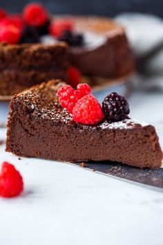 a slice of chocolate cake with raspberries on top