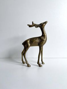 a bronze statue of a deer on a white background