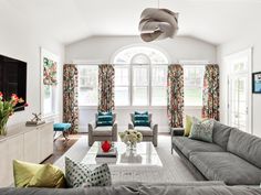 a living room filled with furniture and a flat screen tv