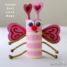 the toilet roll is decorated like a bug with hearts on its wings and eyes,