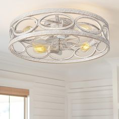 a light fixture in a room with white walls