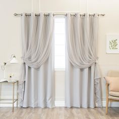 a living room with a chair and window covered in gray drapes, next to a painting on the wall