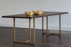 a table with two gold bowls on it