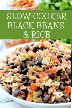 slow cooker black beans and rice in a white bowl on a table with lettuce