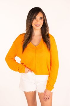 The Sweet Surprise Orange Light Weight Sweater has a bright and happy hue. With a relaxed fit and slightly sheer fabric, it's perfect to wear as we transition into spring. Just pair with a tank or bandeau underneath and you're ready to go. We recommend getting your true size Amanda is 5'3 and is wearing a size small Hand Wash Cold Hang to Dry 67% Polyester & 33% Cotton Vibrant Orange Tops For Day Out, Vibrant Cotton Tops For Spring, Casual Orange Tops For Layering, Spring Orange Stretch Tops, Vibrant Tops For Spring Day Out, Vibrant Relaxed Fit Tops, Trendy Orange Tops For Layering, Stretch Orange Top For Day Out, Stretch Orange Tops For Day Out