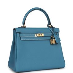 This Kelly, in the Retourne style, is in New Blue Jean togo leather with gold hardware and has contrast stitching,front flap, two straps with center toggle closure, clochette with lock and two keys, single rolled handle and removable shoulder strap.The interior is lined in New Blue Jean chevre and has one zip pocket with Hermes engraved pull and one open pocket on the opposite side.Collection: BOrigin: FranceCondition: New and never worn (plastic on hardware) Accompanied by: Hermes box, Hermes dustbag, clochette, lock, two keys, shoulder strap, clochette dustbag, shoulder strap dustbag, carebook and feltMeasurements: 10" width x 7.5" height x 4.75" depth; 3.5" handle drop (16.5" shoulder strap drop) Classic Blue Bag With Cc Turnlock Closure, Blue Leather Bag With Lock, Blue Office Bag With Turn-lock Closure, Blue Leather Bag With Turn-lock Closure, Hermes Kelly Retourne, Hermes Kelly Bag, Hermes Birkin 25, Hermes Birkin 30, Togo Leather