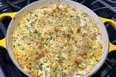 a casserole dish with chicken and noodles in a yellow pan on the stove