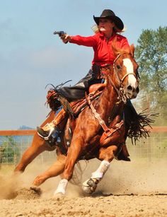 a woman riding on the back of a brown horse