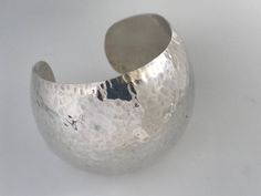 "Vintage Taxco Mexico 925 Silver Extra Wide Hammered Dome Cuff. High quality 925 silver with a versatile design to suit many styles. Quality item weighing 40 grams that is in good vintage condition ready to wear. Markings: 925 Mexico, TA-78 Measurements: Approx 6 1/4\" Total Inside Circumference including the wrist opening, 2 1/8\" inside diameter across, 1 1/8' wrist opening, Total Weight: 40 grams Condition: Good Vintage condition, ready to wear with standard signs of wear for a vintage item s Formal Hammered Silver Cuff Bracelet, Silver Hammered Cuff Bracelet For Formal Occasions, Formal Silver Hammered Cuff Bracelet, Geometric Bangle, Red Topaz, Hammered Sterling Silver, Polish Silver, Hinged Bangle, Silver Cuff