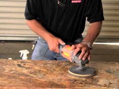 a man using a sander on a piece of wood