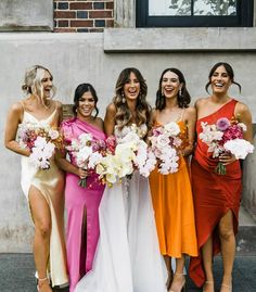 the bridesmaids are all wearing different colored dresses