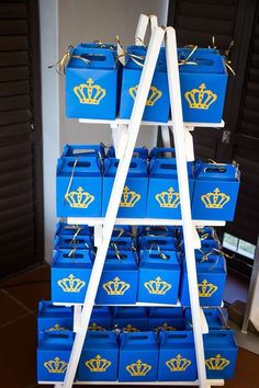 blue boxes with gold crowns are stacked on a shelf