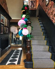 the stairs are decorated with colorful paper flowers