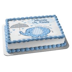 a blue and white cake with an elephant on it