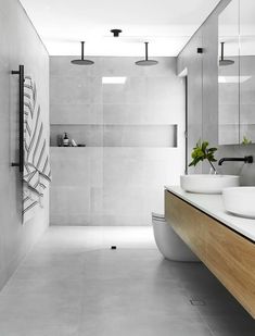 a modern bathroom with two sinks and a large mirror on the wall above it's counter