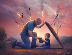 a man kneeling down next to a little boy with fire sticks on his head and holding a book