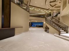 the interior of a large building with white marble flooring and stairs leading up to it