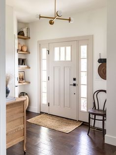 a white door and some shelves in a room