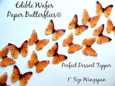 a bunch of orange butterflies sitting on top of a white tablecloth with the words, edible paper butterflies perfect dessert topper