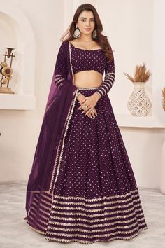 This designer lehenga choli in a rich wine color is crafted from luxurious georgette fabric, adorned with sparkling sequins embroidery that enhances its sophistication. The outfit, complete with a matching dupatta, is perfect for weddings, receptions, and evening gala events, offering a blend of traditional charm and contemporary elegance. #lehnga #lehengacholi #indianfashion #ethnicwear #traditionaldress Lehenga For Party, Wine Lehenga, Georgette Material, Lehenga Choli Wedding, Stitched Lehenga, Party Wear Lehenga Choli