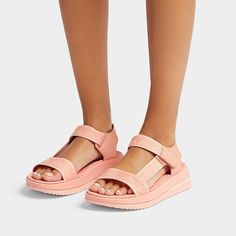 Our next-generation athleisure sandals fuse refined modern style with our never-bettered original technology. Boasting a utilitarian chunky-sole silhouette, clean lines, and wide foot-hugging straps. Here crafted from soft recycled webbing, featuring the Fit Flop 'arrow' as a repeat pattern, in a palette of summery pastel shades. With leather detailing and an adjustable hook-and-loop back strap for easy on/off. On a sporty-look version of our supercushioning Microwobbleboard™ midsole. (In a new Leather Detailing, Office Shoes, Waterproof Shoes, Pastel Shades, Repeat Pattern, Platform Wedge Sandals, Slipper Shoes, Slipper Boots, Sporty Look