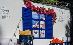 blue and white building with flowers on the window