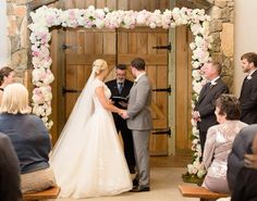 a bride and groom are getting married at the alter