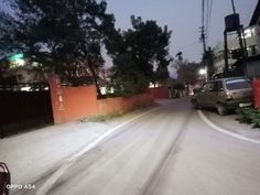 a car is driving down the street at night