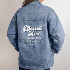 Our Blessed Mom Denim Blue Jean Jacket is perfect for mom's birthday or Mother's Day. This stylish custom-designed Oversized Women's Denim Jean Jacket is a perfect blend of classic fashion and personal expression. The back of the jacket features the phrase "Blessed Mom," along with a personalization area to include the names of up to nine children. This boyfriend-style denim jacket offers not just warmth and comfort but a beautifully unique design you won't find anywhere else. Stylishly Versatil Oversized Medium Wash Cotton Denim Jacket, Mama Jean Jacket, Mommy And Me Jean Jacket, Denim Jacket With Name On Back, Oversized Single-breasted Collared Denim Jacket, Mom Denim, Blue Jean Jacket, Boyfriend Style, Denim Jean Jacket