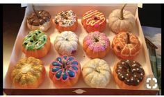 a box filled with lots of different types of doughnuts on top of each other