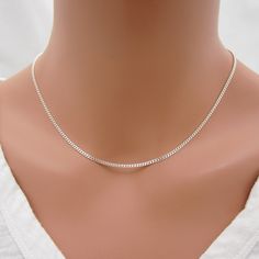 SOLID STERLING SILVER CURB CHAIN NECKLACE This little beauty features a classic curb chain but in a small link size - perfect for a dainty look. It features solid sterling silver links in a 2mm size. Closes with a quality spring-ring clasp for an easy on/off. Comes in a gift box.  - 925 Sterling Silver - your choice of length - tiny 2mm links - comes in gift box Dainty Silver Necklace With Curb Chain, Cheap Silver Necklace With Curb Chain, Minimalist Sterling Silver Curb Chain, Sterling Silver Necklace With Curb Chain, Sterling Silver White Gold Curb Chain Necklace, Affordable Sterling Silver Curb Chain Necklace, Beauty Features, Curb Chain Necklace, Silver Chain Style