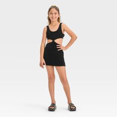 Your kiddo can layer their swimsuit while lounging on the beach or returning home from their swim session with this Solid Terry Cover-Up Dress from art class™. This sleeveless cover-up dress in a solid color features a center knot detail along with cutout sides and back for a stylish, breezy look. The cotton-blend terry fabric offers a cool and comfortable fit, while the pullover style allows for easy wear. Plus, the UPF 50+ rated finish offers added protection from UV rays. Welcome to art class Casual Mini Dress For School In Spring, Black Summer Beachwear Swimwear, Playful Black Summer Dress, Black Sleeveless School Dress, Summer School Mini Dress, Casual Sleeveless Swim Dress For Spring, Casual Mini Swim Dress For Poolside, Casual Mini-length Swim Dress For Poolside, Casual Black Swim Dress