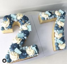 the number seven cake is decorated with blue and white icing