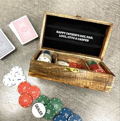 a wooden box filled with playing cards and dices